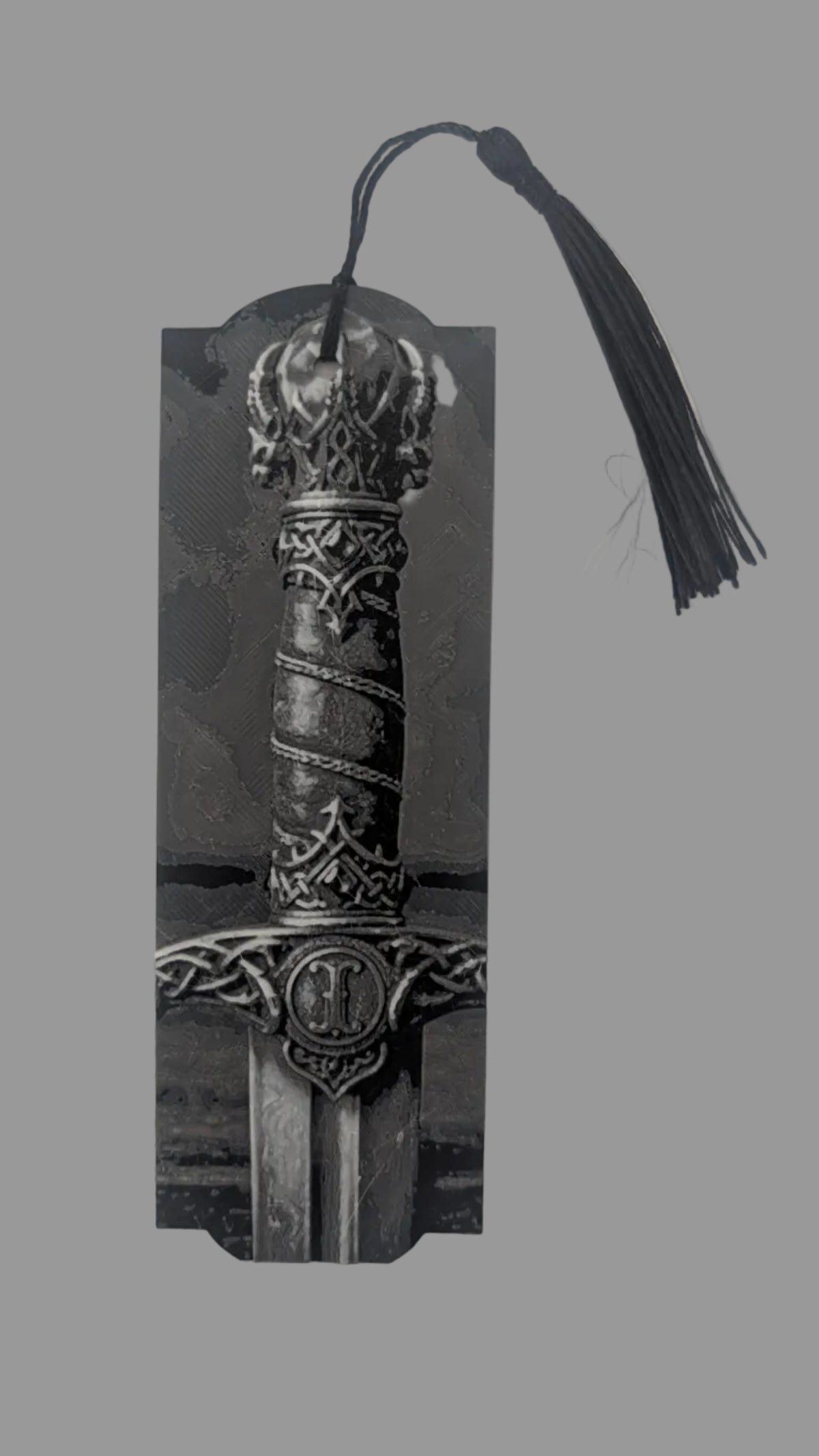 Decorative bookmark with a sword design on a light gray background